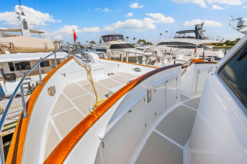 Slide: The Image of 2008 DeFever 52 Euro yacht deck, docked among other luxury boats under a blue sky. - 27