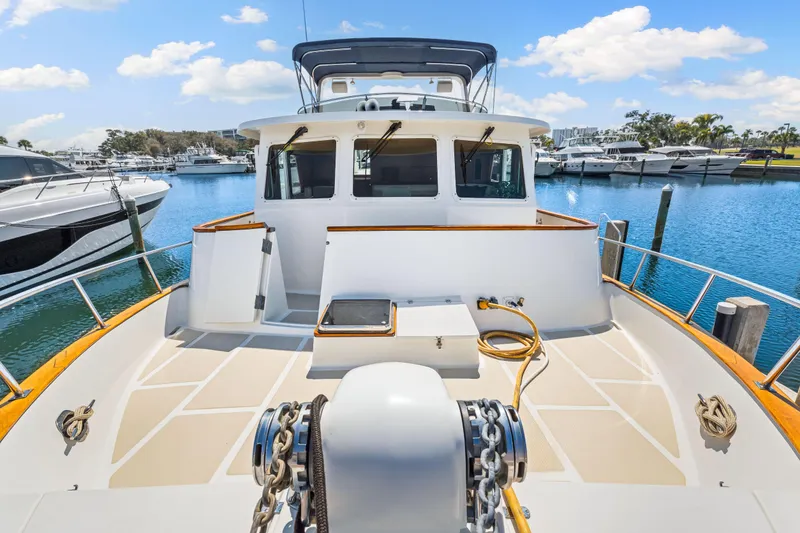 Slide: The Image of 2008 DeFever 52 Euro yacht docked at marina under blue sky. - 30