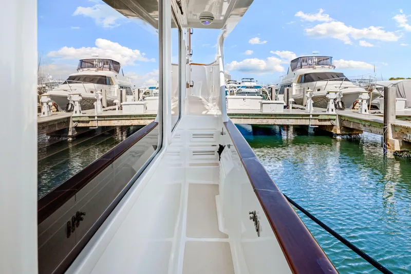 Slide: The Image of 2008 DeFever 52 Euro yacht docked, showcasing sleek design and marina view. - 32