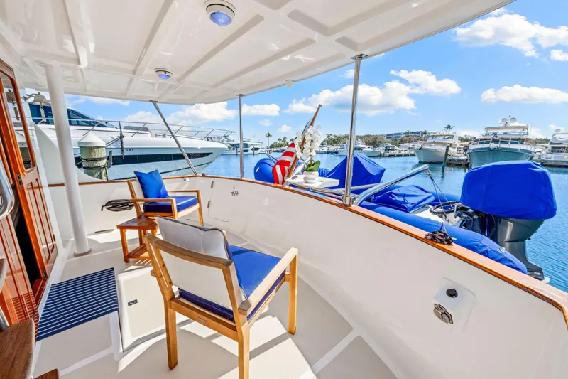 Slide: The Image of 2008 DeFever 52 Euro yacht deck with chairs, marina view, and blue sky. - 34
