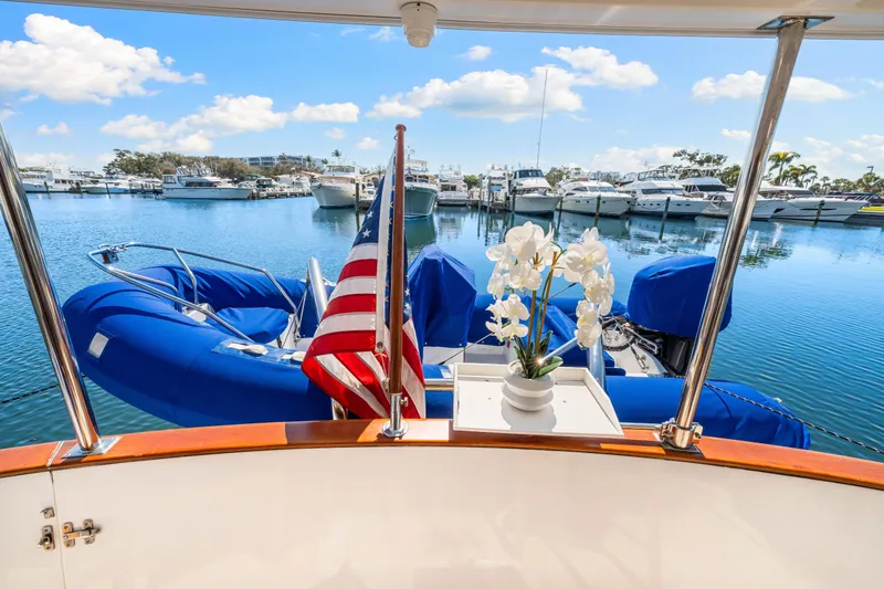 Slide: The Image of 2008 DeFever 52 Euro yacht with American flag and flowers, docked in a marina. - 37