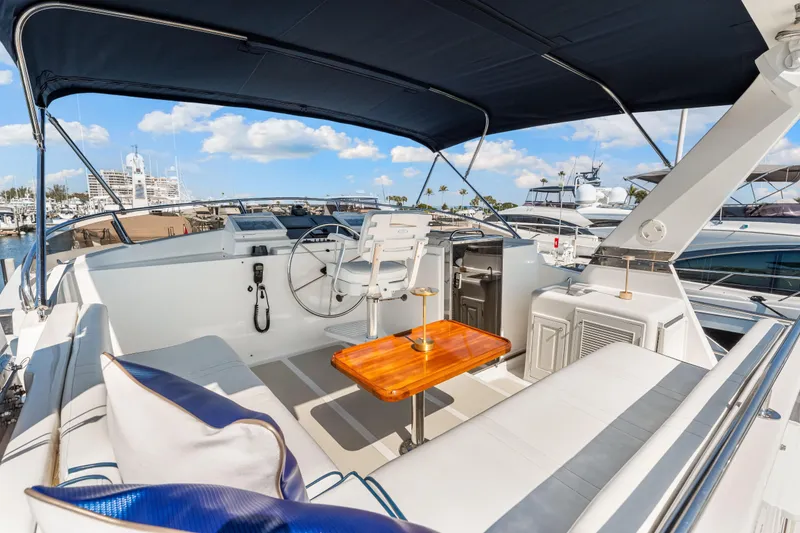 Slide: The Image of 2008 DeFever 52 Euro yacht interior with helm, seating, and table under canopy. - 40