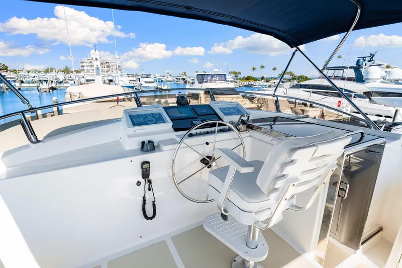 Slide: The Image of 2008 DeFever 52 Euro yacht helm with marina view, featuring modern navigation equipment. - 44