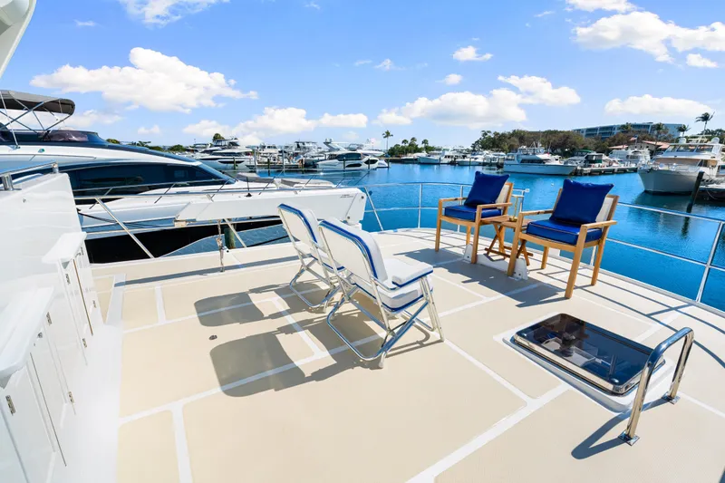 Slide: The Image of 2008 DeFever 52 Euro yacht deck with chairs, overlooking marina and blue sky. - 47