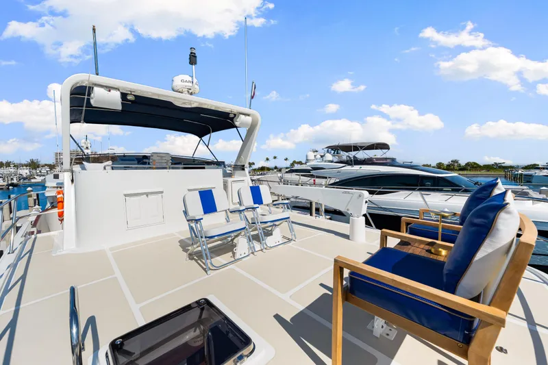 Slide: The Image of 2008 DeFever 52 Euro yacht deck with seating, marina view, and blue sky. - 49