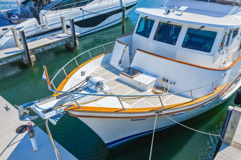 Slide: The Image of 2008 DeFever 52 Euro yacht docked at marina, showcasing sleek design and spacious deck. - 6