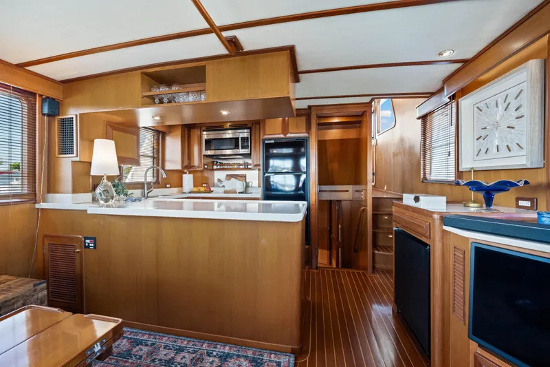 Slide: The Image of Luxurious 2008 DeFever 52 Euro yacht interior with modern kitchen and elegant wood finishes. - 65