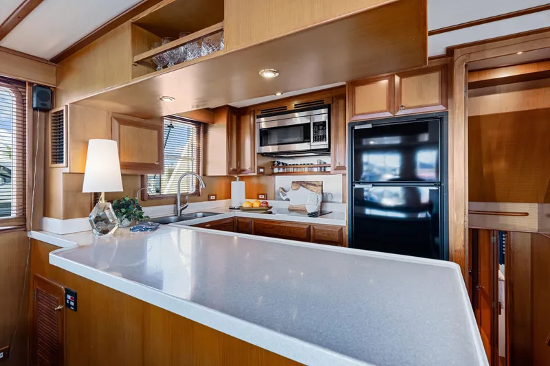 Slide: The Image of Luxurious 2008 DeFever 52 Euro yacht kitchen with modern appliances and elegant wood cabinetry. - 66
