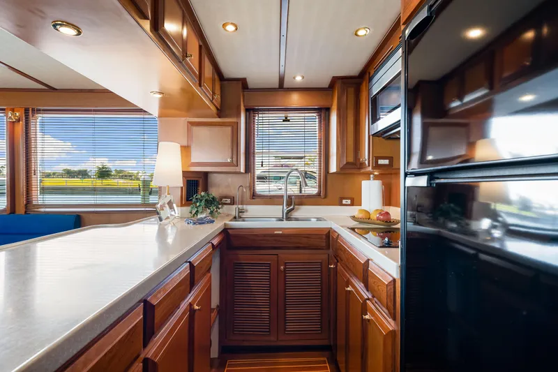 Slide: The Image of Luxurious kitchen interior of 2008 DeFever 52 Euro yacht with wooden cabinetry and modern appliances. - 67