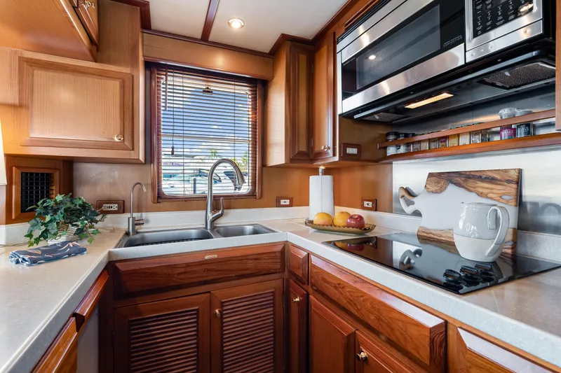 Slide: The Image of Luxurious 2008 DeFever 52 Euro yacht kitchen with modern appliances and elegant wood cabinetry. - 68