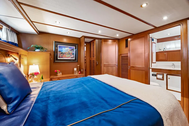 Slide: The Image of Luxurious 2008 DeFever 52 Euro yacht bedroom with elegant wood paneling and blue bedding. - 71