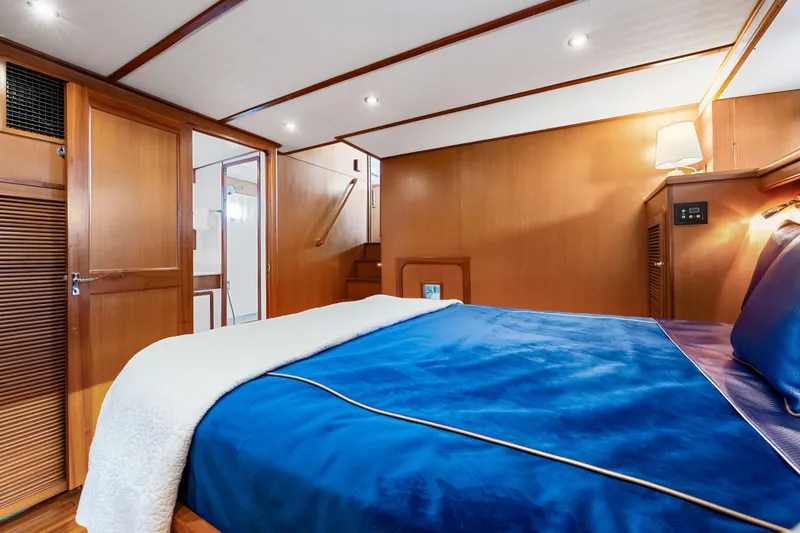 Slide: The Image of Luxurious cabin interior of 2008 DeFever 52 Euro yacht with blue bedding and wooden accents. - 72