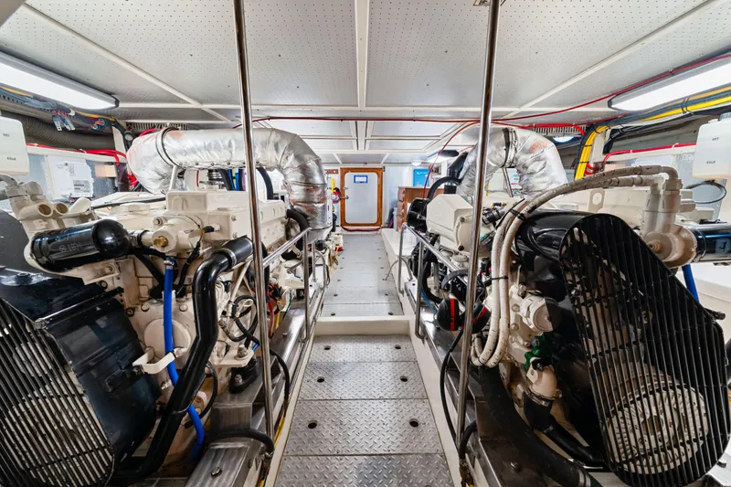 Slide: The Image of Engine room of 2008 DeFever 52 Euro yacht, featuring dual engines and modern equipment. - 77