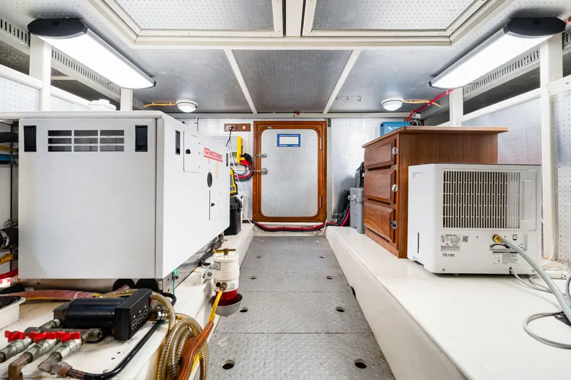 Slide: The Image of Engine room of 2008 DeFever 52 Euro yacht with equipment and storage. - 78