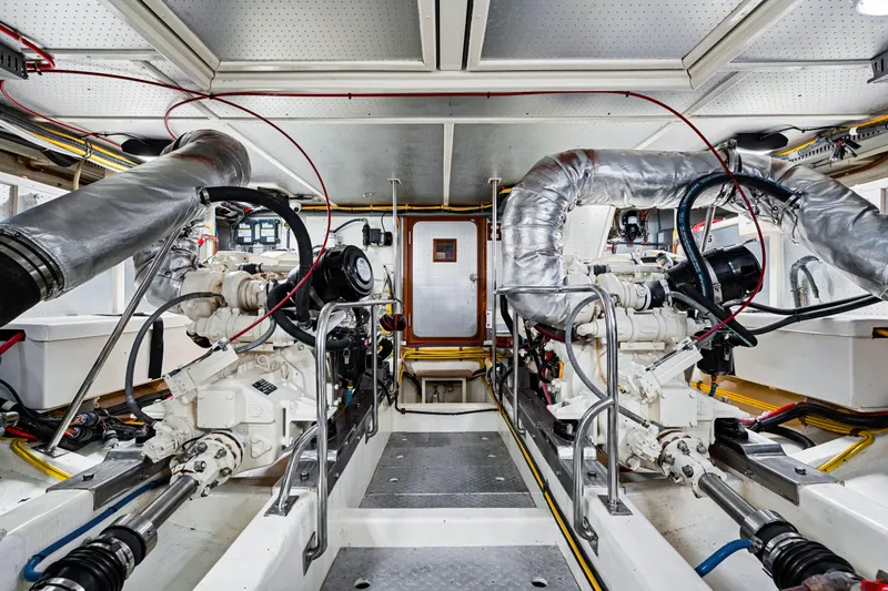 Slide: The Image of Engine room of 2008 DeFever 52 Euro yacht, showcasing dual engines and mechanical systems. - 79