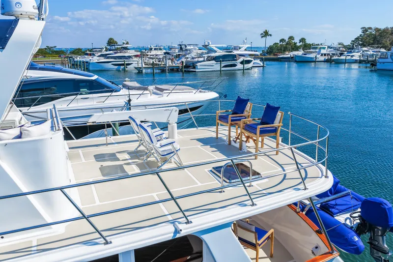 Slide: The Image of 2008 DeFever 52 Euro yacht with spacious deck, docked in a marina under clear skies. - 8