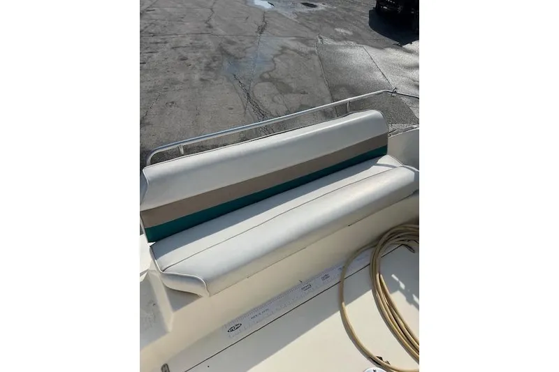 Slide: The Image of 1996 Rinker Fiesta Vee 265 boat seat with striped upholstery. - 12