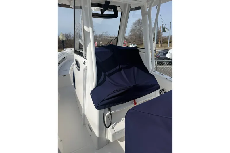 Slide: The Image of 2024 Regulator 28 Forward Seating boat interior with navy covers and modern design. - 13