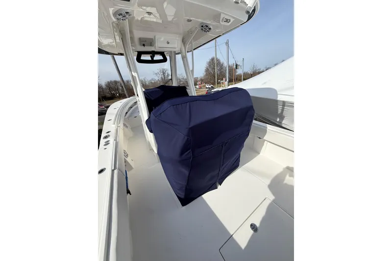 Slide: The Image of 2024 Regulator 28 Forward Seating boat interior with covered seats and console. - 14