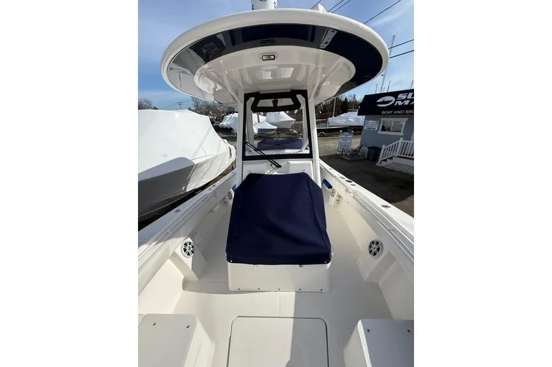 Slide: The Image of 2024 Regulator 28 Forward Seating boat with blue cushions and sleek design. - 15