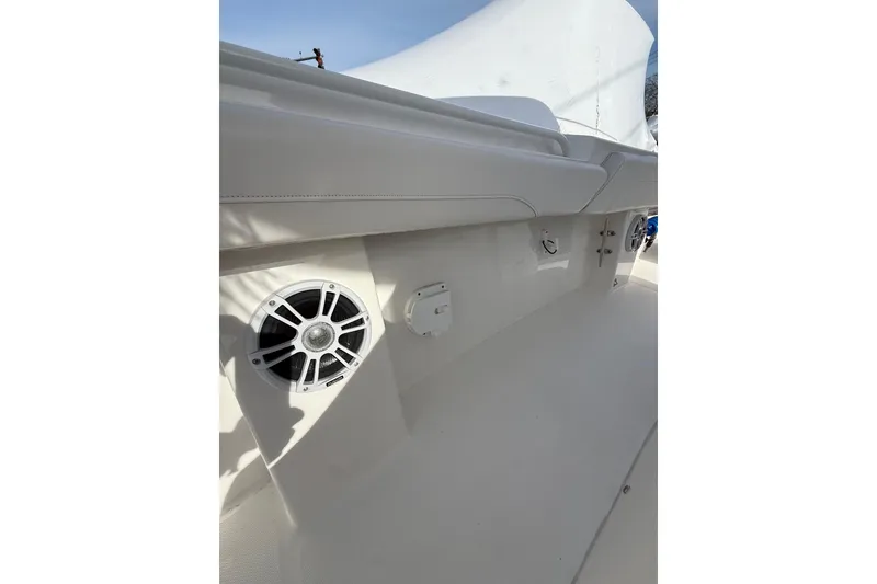Slide: The Image of 2024 Regulator 28 Forward Seating boat interior with speaker and seating detail. - 19