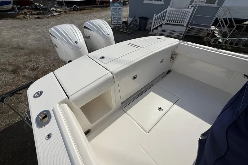 Slide: The Image of 2024 Regulator 28 Forward Seating boat with dual Yamaha engines, spacious deck view. - 20