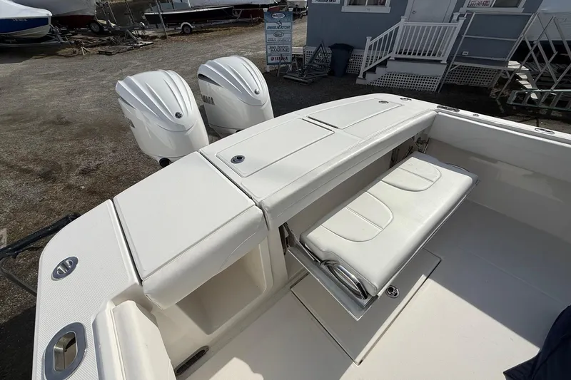 Slide: The Image of 2024 Regulator 28 Forward Seating boat with dual outboard engines and white seating. - 22