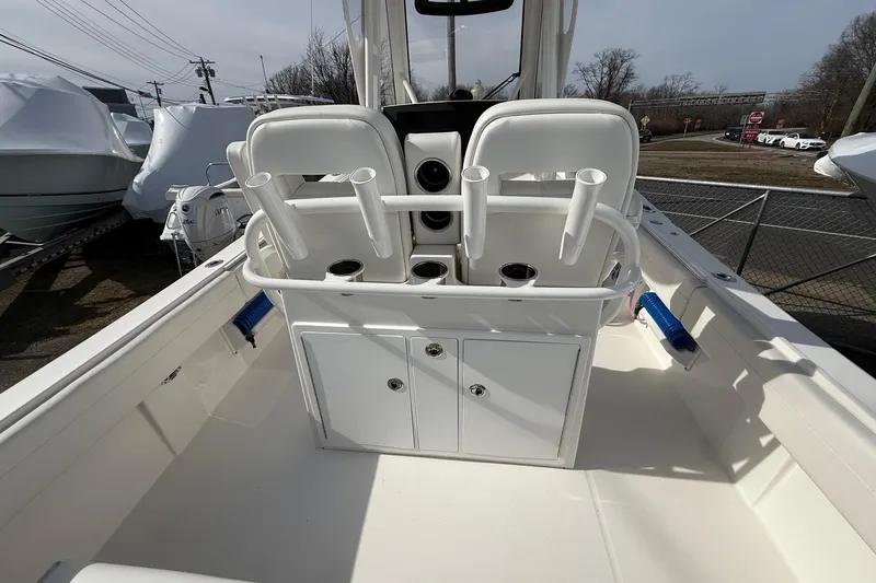 Slide: The Image of 2024 Regulator 28 Forward Seating boat interior with rod holders and storage compartments. - 24