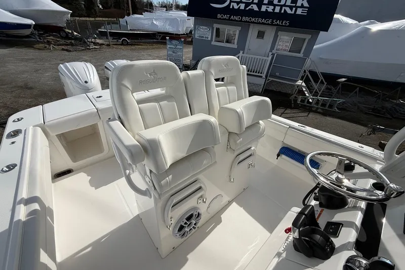 Slide: The Image of 2024 Regulator 28 Forward Seating boat with dual helm seats and steering wheel. - 28
