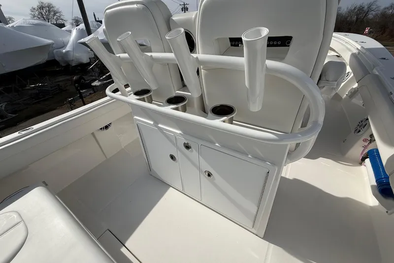 Slide: The Image of 2024 Regulator 28 Forward Seating boat interior with rod holders and storage compartments. - 30