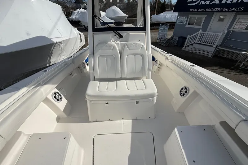 Slide: The Image of 2024 Regulator 28 Forward Seating boat interior with white cushioned seats and speakers. - 32