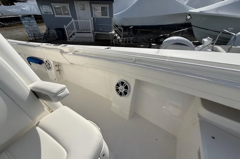 Slide: The Image of 2024 Regulator 28 Forward Seating boat interior with white seating and speakers. - 34