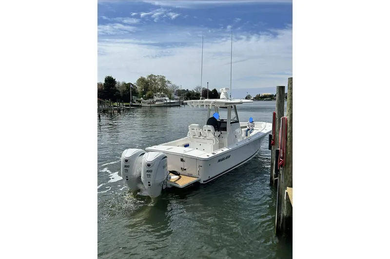 Slide: The Image of 2024 Regulator 28 Forward Seating boat docked with twin Yamaha engines. - 5