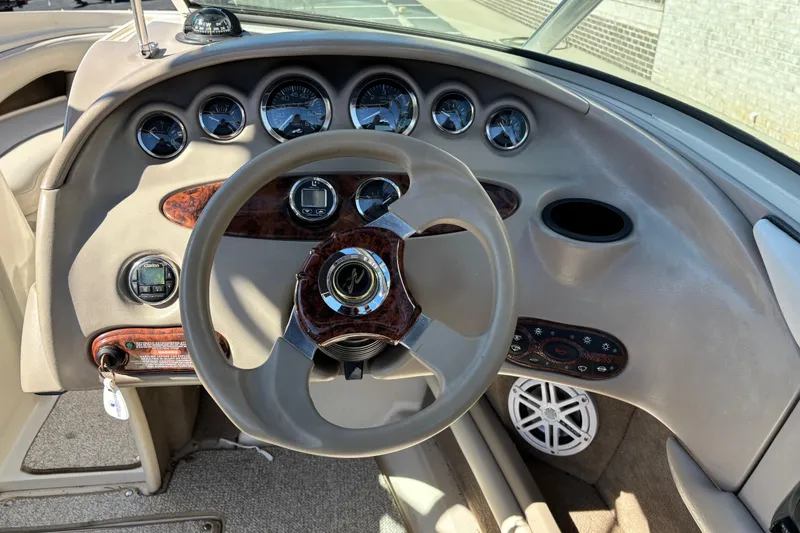 Slide: The Image of Dashboard of a 2003 Sea Ray 200 Bow Rider boat with steering wheel and gauges. - 10