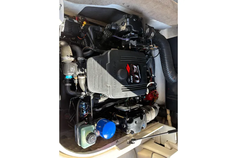 Slide: The Image of Engine compartment of a 2003 Sea Ray 200 Bow Rider boat, featuring a MerCruiser 5.0 MPI engine. - 14