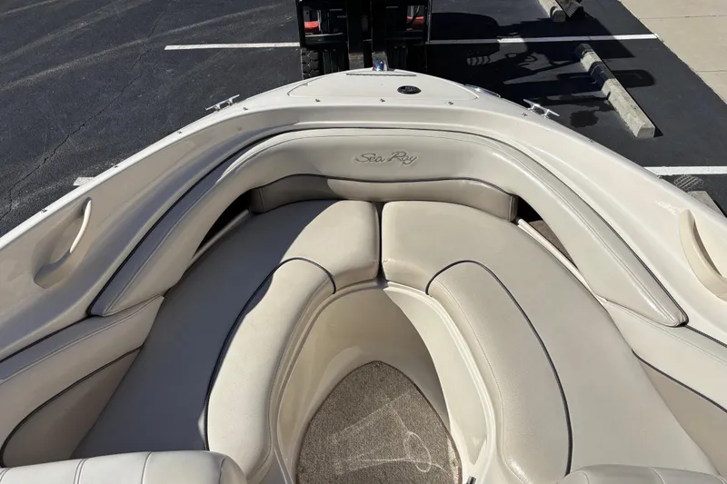 Slide: The Image of 2003 Sea Ray 200 Bow Rider boat interior with beige seating and logo. - 6