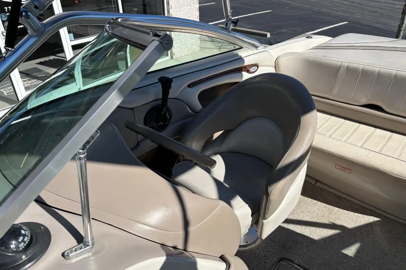 Slide: The Image of Interior of a 2003 Sea Ray 200 Bow Rider boat, featuring seating and controls. - 8