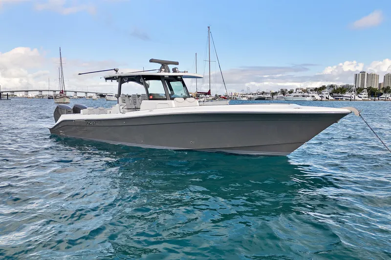 The Image of 2023 HCB 39 Speciale boat on calm blue water, anchored near a marina. - 0