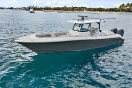 The Image of 2023 HCB 39 Speciale boat on clear blue water near a coastline. - 1