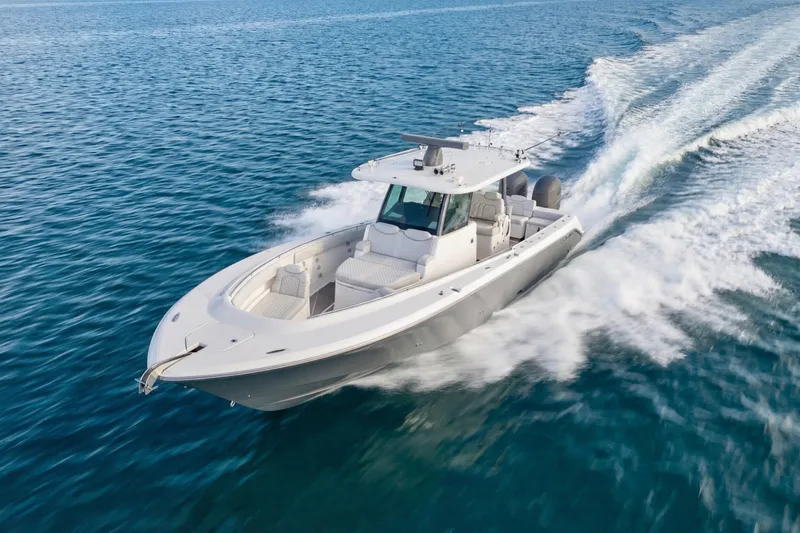 Slide: The Image of 2023 HCB 39 Speciale boat cruising on open water, showcasing sleek design and powerful performance. - 10