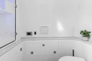 Slide: The Image of 2023 HCB 39 Speciale boat interior, featuring a sleek white bathroom with modern fixtures. - 11
