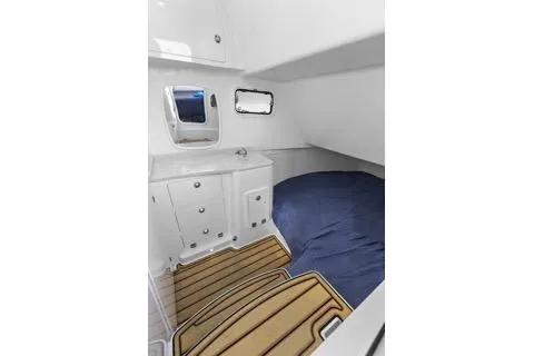 Slide: The Image of 2023 HCB 39 Speciale cabin interior with bed, storage, and porthole window. - 13
