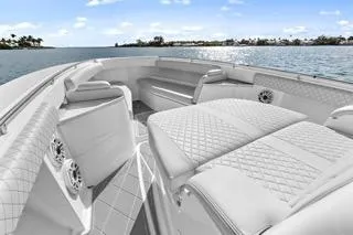 Slide: The Image of 2023 HCB 39 Speciale luxury boat interior with quilted seating, on a sunny day. - 14
