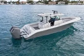 Slide: The Image of 2023 HCB 39 Speciale boat on open water, showcasing sleek design and powerful engines. - 3