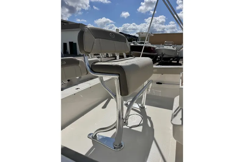 Slide: The Image of 2021 Key West 189 FS boat seat with chrome frame under a sunny sky. - 10