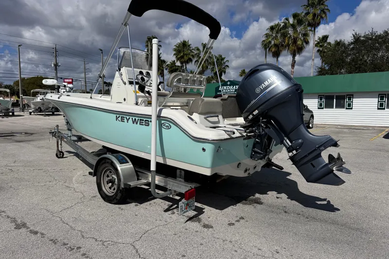 Slide: The Image of 2021 Key West 189 FS boat on trailer with Yamaha outboard motor, parked outdoors. - 2