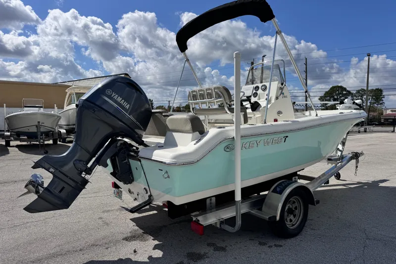Slide: The Image of 2021 Key West 189 FS boat with Yamaha outboard motor on a trailer, parked outdoors. - 4