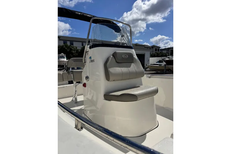 Slide: The Image of 2021 Key West 189 FS boat with console and seating, under a sunny sky. - 8