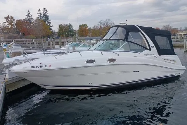 Slide: The Image of 2006 Sea Ray Sundancer 260 boat docked at marina, overcast sky. - 1