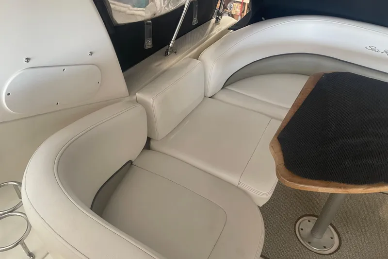 Slide: The Image of Interior seating of 2006 Sea Ray Sundancer 260 with wooden table. - 10